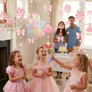 Pink princess garland with crowns, castle icons, bows, stars, and bead strings on wall