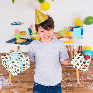 Child wearing party hat holding two gifts wrapped in pixel game icons paper
