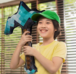 Pickaxe-shaped foil balloon held by child, teal and black check with brown diamond stripe