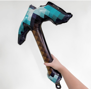 Pickaxe-shaped foil balloon close-up, teal and black check with brown diamond stripe