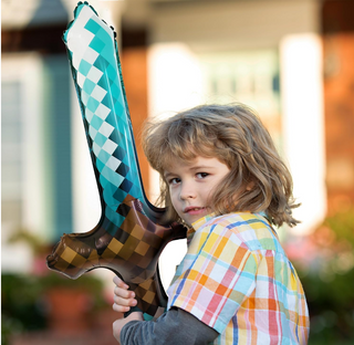 Child holding teal and brown argyle long sword foil balloon at shoulder height