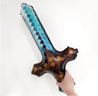 Hand holding long sword foil balloon with teal-and-brown argyle check pattern