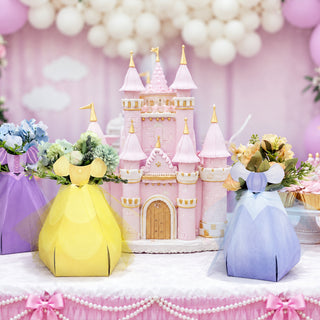 Three pastel flower centerpiece bags—yellow, blue, and purple—with bow tops
