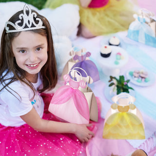 Princess dress gift bag in pink tulle-style design held by a child with other bags