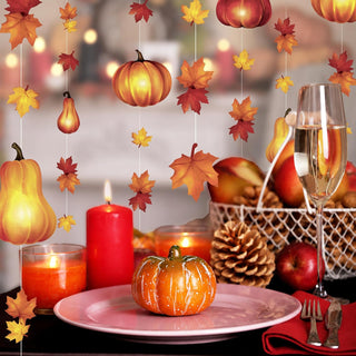 Autumn pumpkin and leaf garland draped backdrop with hanging gourds and maple leaves