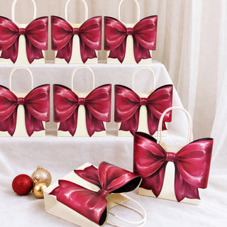 Set of cream gift bags with burgundy satin bows and rope handles