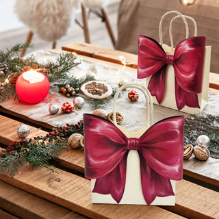 Cream gift bag with large burgundy bow and rope handles