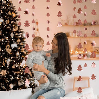 Christmas tree garland with rose gold and pink tree ornaments hanging from thin strings