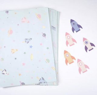 Opened rocket-and-planet wrapping paper sheets, pastel colors with stars