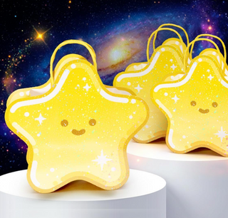 Star-shaped yellow gift bags with loop handles, stacked on a white surface