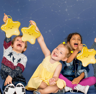Star-shaped yellow gift bags with loop handles, held up in a party scene