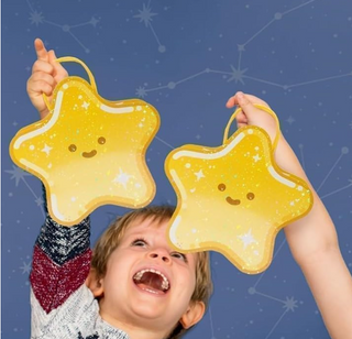 Two star-shaped yellow gift bags with loop handles against a blue backdrop