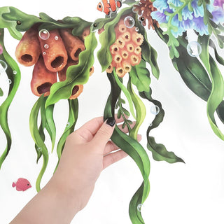 Seaweed coral garland strip with hanging seaweed and coral cutouts, held by hand