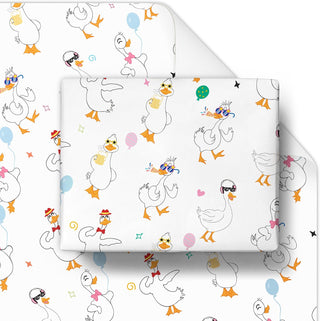 Birthday gift wrapping paper, white with cartoon geese, balloons, and party confetti.