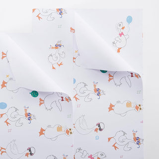 White wrapping paper with repeating line-drawn geese, balloons, and party accessories.