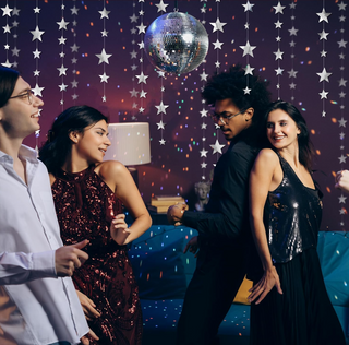 Silver star garlands kit with star strands draped overhead for a party scene