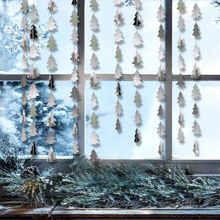 Silver pine tree garland hanging vertically with glittered leaves and star-like tips