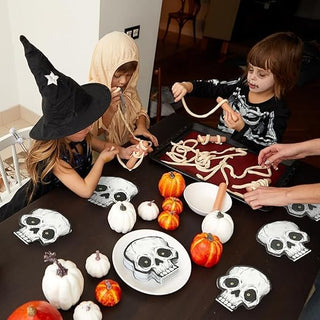 Skull paper napkins set on Halloween table, black-and-white skull motifs