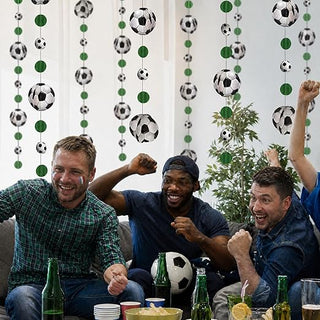 Soccer ball and green circle hanging garland, streamers above a party table