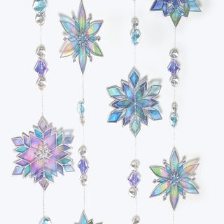 Stained glass snowflake garland close-up of iridescent snowflake ornaments and bead links