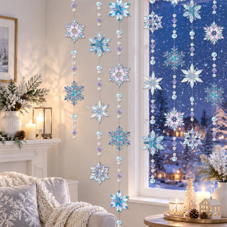 Stained glass snowflake garland hanging from a window with blue iridescent snowflake ornaments