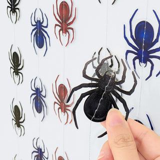 Spider garland close-up with black spider figures on white backing