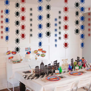 Spider garland pattern spread across a wall, red blue and black spider silhouettes