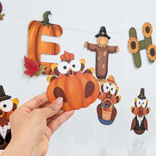 Handheld Thanksgiving banner letter cutout with turkey, bear, and owl characters