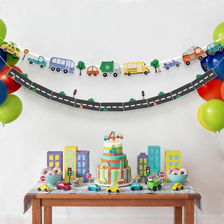 Curved transport road banner with buses, trucks, cars, and trees across a wall