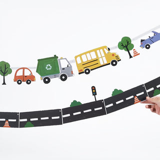 Curved road transport banner with colorful trucks, buses, cars, and trees