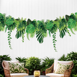 Tropical leaf banner garland with green palm leaf cutouts, draped in a scalloped row