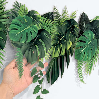 Tropical leaf banner close-up, green palm leaf garland held in hand