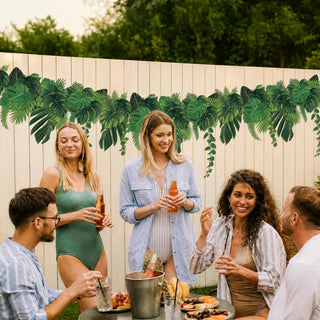 Tropical leaf banner garland hanging behind party guests, green palm leaf pattern