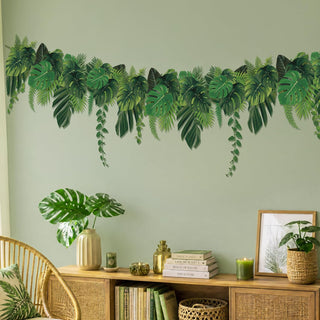 Tropical leaf banner garland above tabletop, green palm leaf cutouts