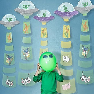 UFO alien garland with stacked yellow rings and dangling green alien and animal character strips