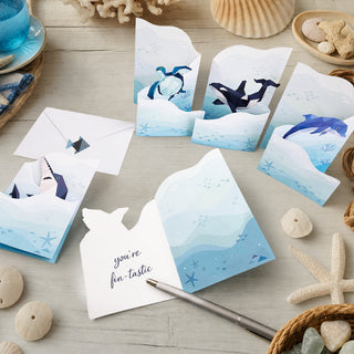 Stack of undersea greeting cards and envelopes with folded fish designs