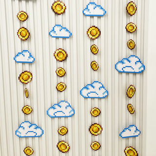 Pixel garland hanging on a light background with blue clouds and gold coins