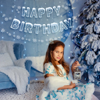 HAPPY BIRTHDAY banner with icy blue balloon letters and scattered white snowflakes