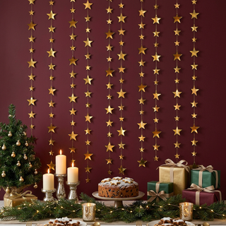Gold star garlands hanging in rows of vertical strands with varied star sizes