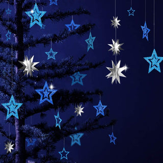Blue outline and metallic silver star garland hanging among evergreen branches
