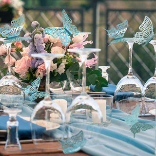 Teal blue butterfly wall stickers for party decorations on a decorated table
