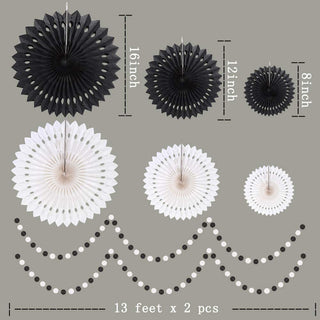 Black and white paper rosettes and dot garland strands displayed with measurements