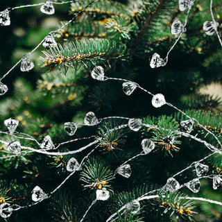 Crystal beaded diamond garland wrapped on tree branches with faceted hanging drops