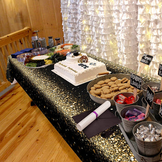 Champagne gold glitter tablecloth on long banquet table with decorations