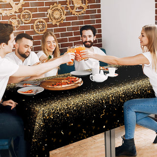 Champagne gold glitter tablecloth on dining table with pizza and drinks