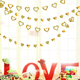 Gold heart garland with glittery metallic hearts, draped across an indoor space