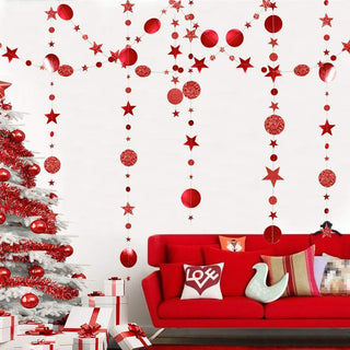 Red hanging star and circle garland streamer strands across wall with glitter dots