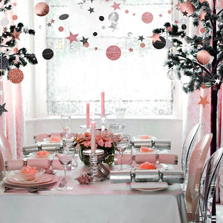 Twinkle star and glitter circle dot hanging garland draped across an arch backdrop