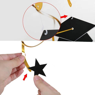 Cap cutout is tied to the end of a swirl with a hook; hand using glue dot to stick star cutout to another swirl