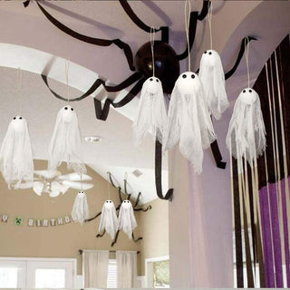 Hanging ghost decorations with white tulle sheets and black eyes, multiple on strings